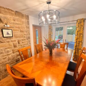 Dining room with feature stone wall.