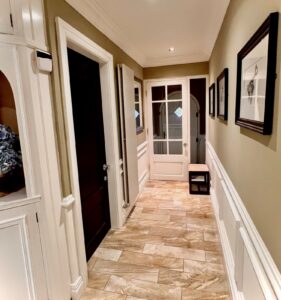 Tiled hallway with georgian style half height wall panelling.