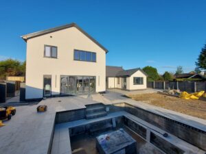 White render Bungalow renovation and double storey side extension with sunken seating area.